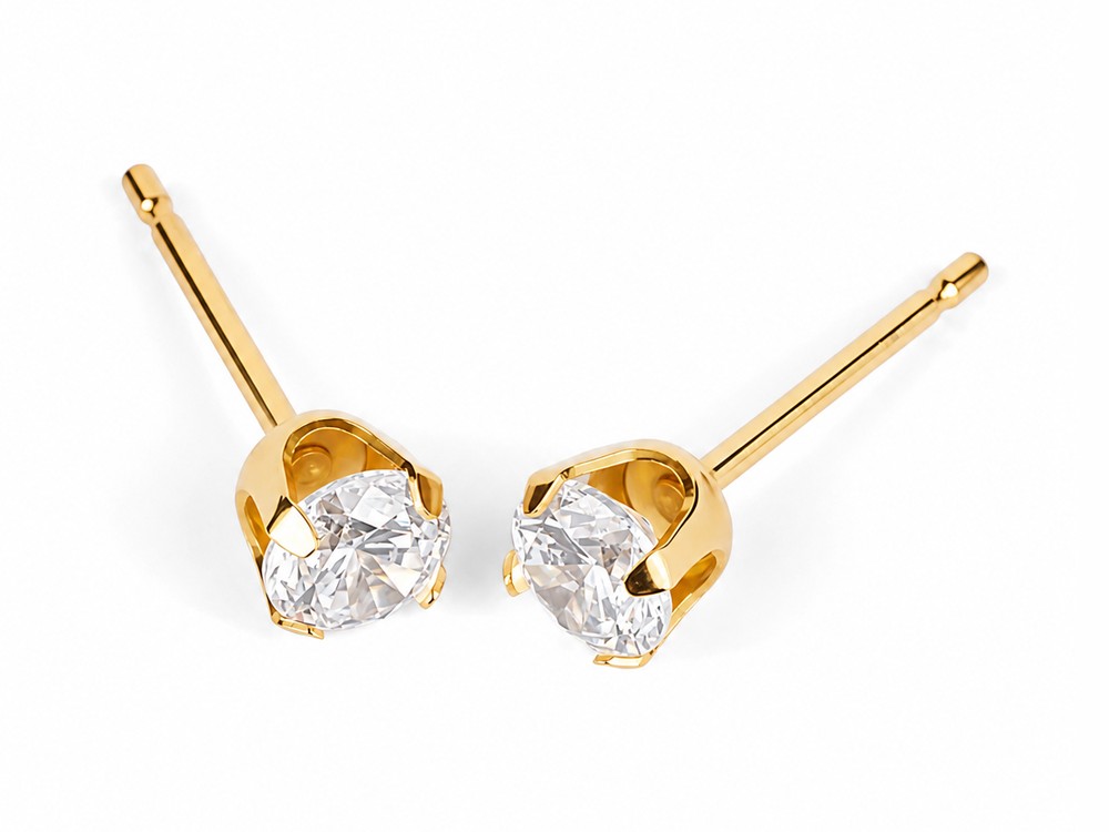 A pair of purepixxi 4mm Flawless Crystal claw-set studs in pure 24 karat gold.