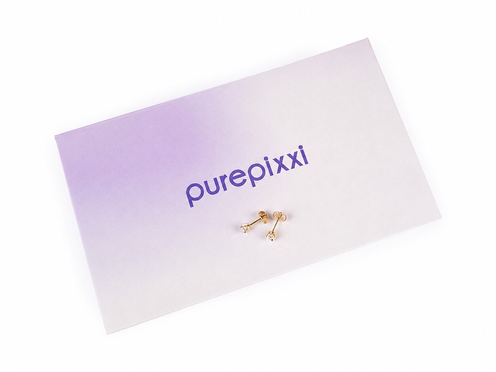 A pair of purepixxi Flawless Crystal studs resting on a branded purepixxi gift box.